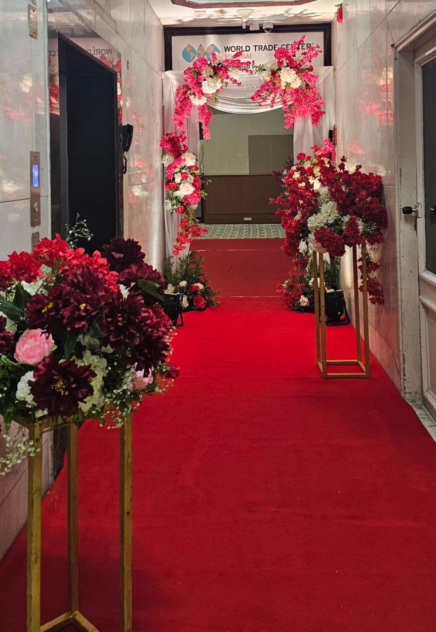 Royal red carpet entrance walkway with gold floral urns