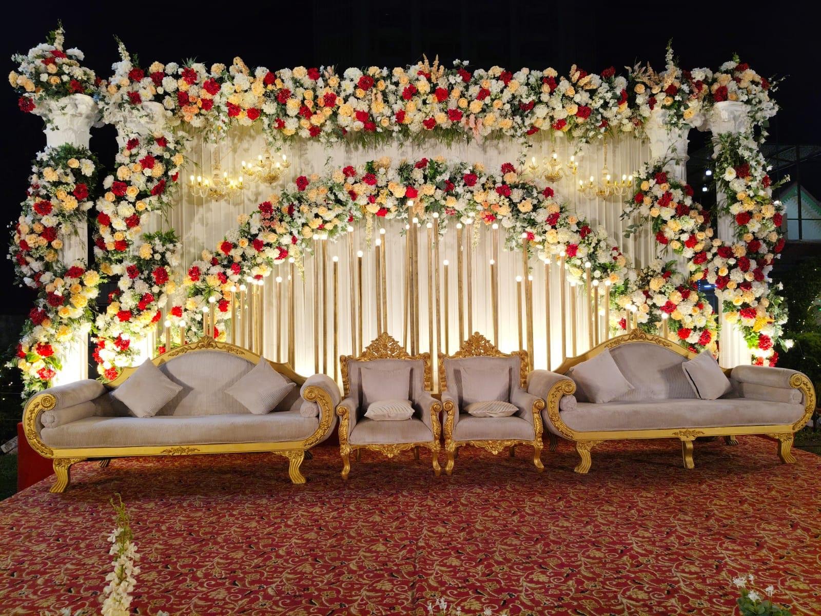 Real ivory and white floral wedding stage setup detail